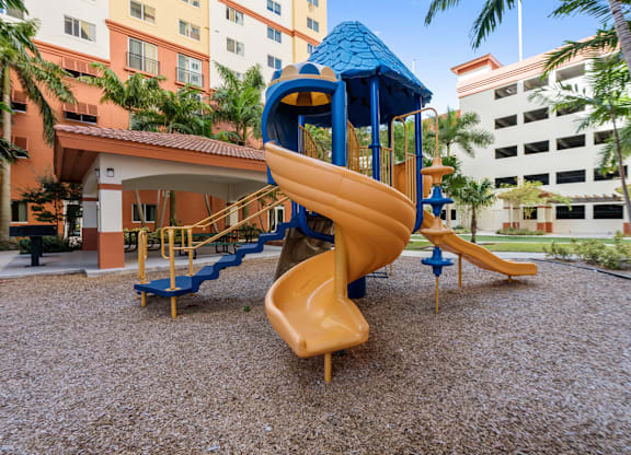 A playground with a blue roofed slide and a yellow slide.