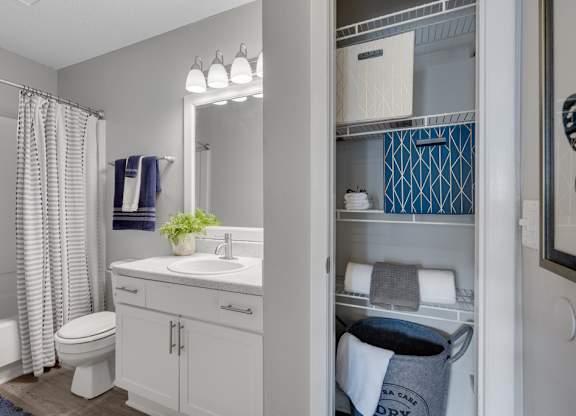 A bathroom with a white sink and a white toilet.