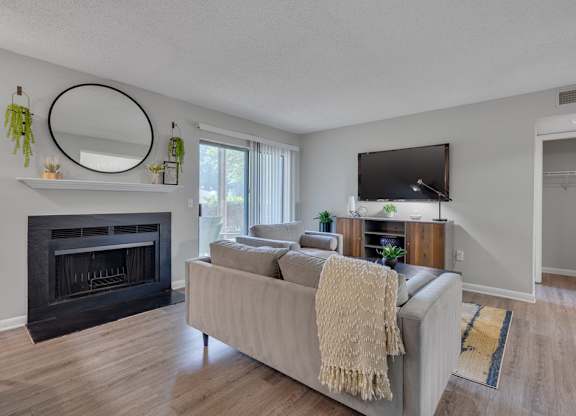 A living room with a fireplace and a couch.