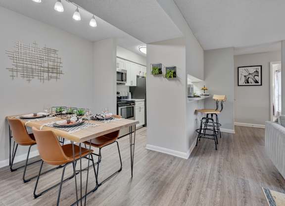 A dining room with a table set for four.