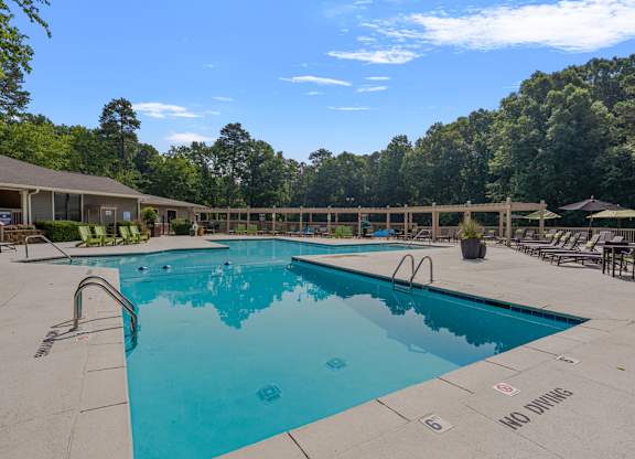 A large swimming pool with a no diving sign.