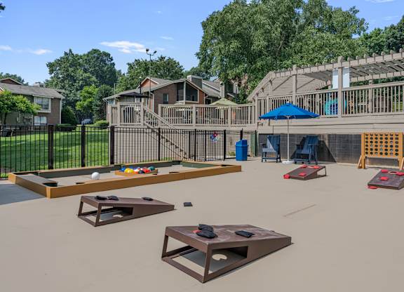 A playground with a slide, swings, and other equipment.
