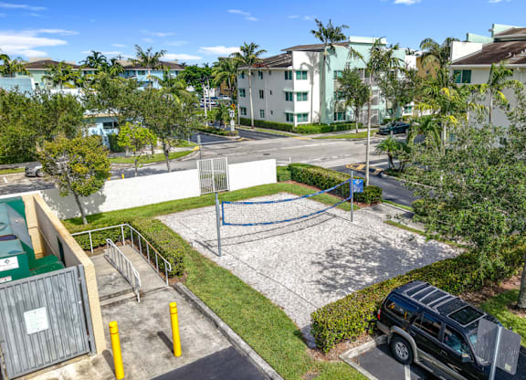 A parking lot with cars and a building in the background.