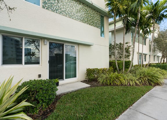 A white building with a green pattern on the wall.
