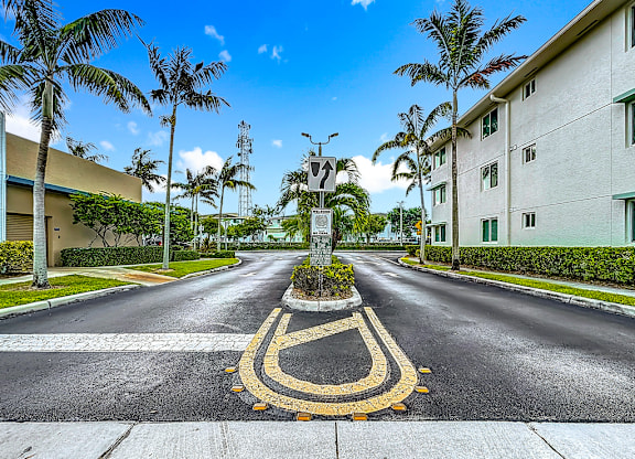 A road with a yellow painted crosswalk in the middle.