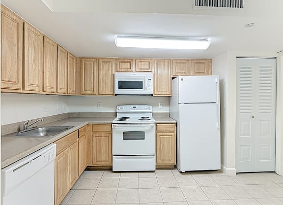 kitchen with white appliances and wooden cabinetry