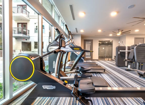 Fitness center area facing a stair climber and exterior windows