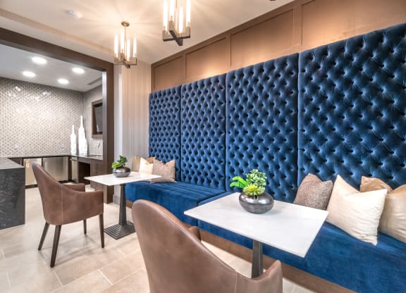 Resident common area facing two booth seats and decorative lighting