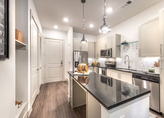 Kitchen area facing entry doorway and island area.