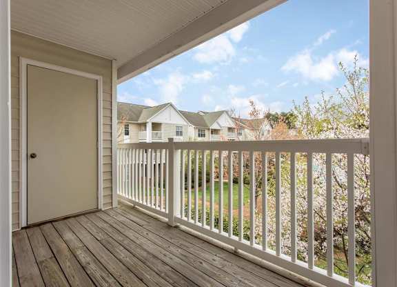 Private Balcony with Wood Flooring and White Railing