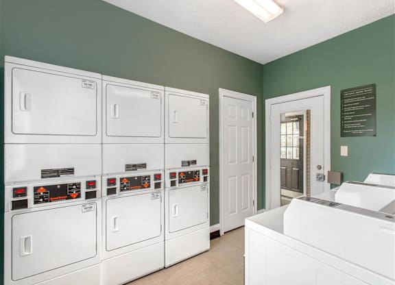 Clothes Care Center with Dryer Machines and Blue Walls