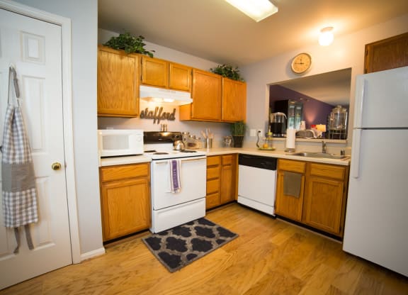 Kitchen with white appliances and wood cabinets