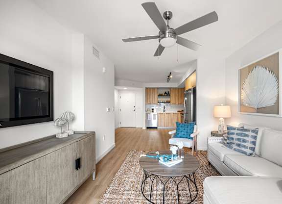 a living room with a couch and a ceiling fan