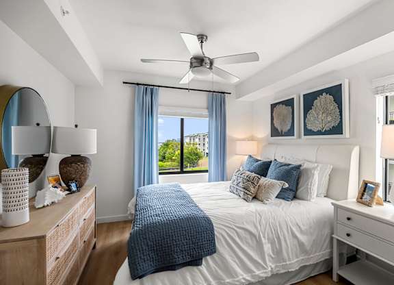 a bedroom with a large bed and a ceiling fan