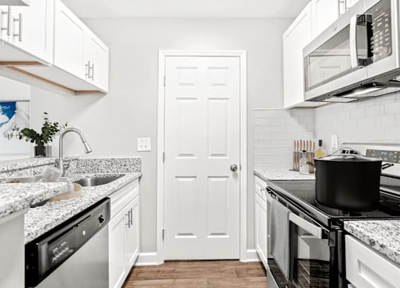 A kitchen with a black pot on the stove at Paces Pointe Apartment Homes, Matthews, NC