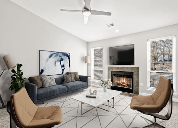 A living room with a fireplace and a painting of a woman at Paces Pointe Apartment Homes, Matthews, NC