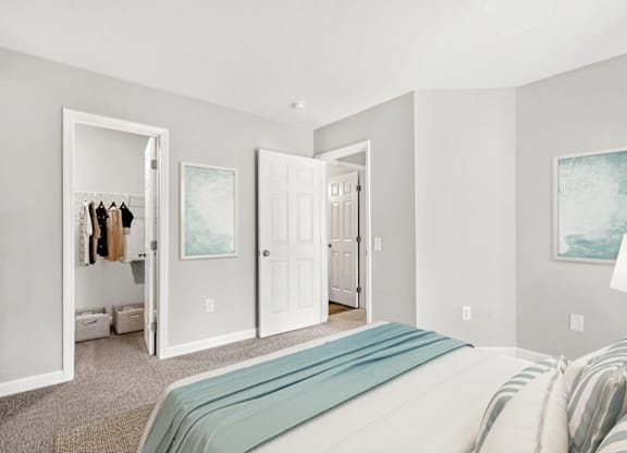 A bedroom with a large bed and a painting on the wall at Paces Pointe Apartment Homes, North Carolina