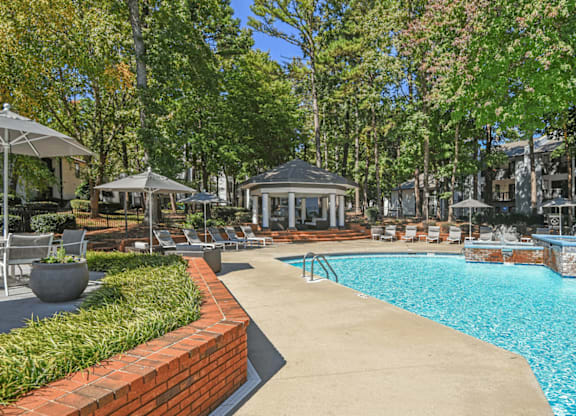 A pool area with a brick border and a gazebo at Paces Pointe Apartment Homes, North Carolina, 28105
