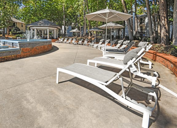 A row of sun loungers are arranged in a row in a sunny courtyard at Paces Pointe Apartment Homes, Matthews, NC