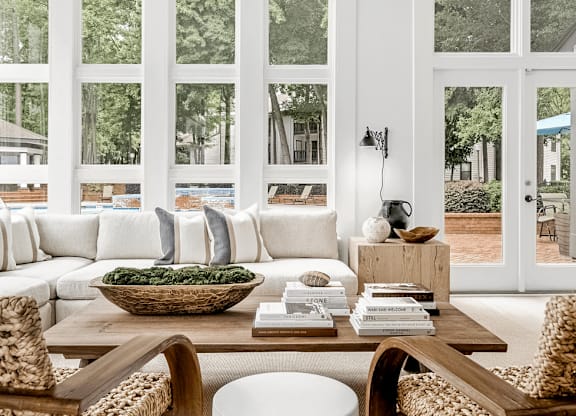 A living room with a white couch and a wooden coffee table at Paces Pointe Apartment Homes, Matthews, 28105