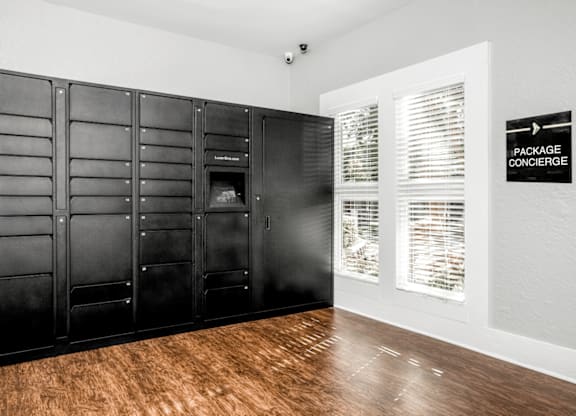 A room with a black wardrobe and a sign at Paces Pointe Apartment Homes, Matthews, NC