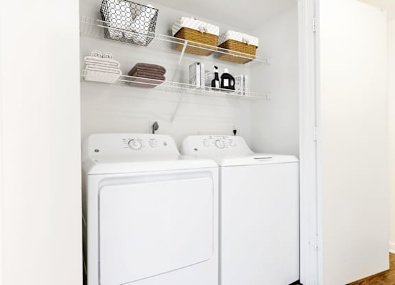 a small laundry room with a washer and dryer at The Parke at Trinity Apartment Homes, North Carolina, 27607