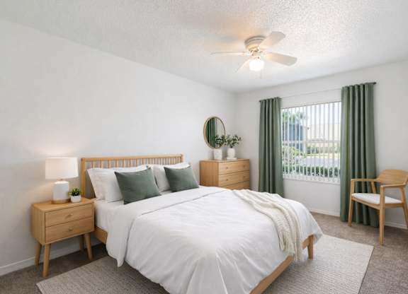 A bedroom with a bed, nightstand, and chair.
