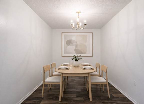 A dining room with a table set for two.