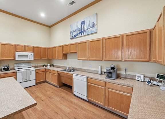 A kitchen with wooden cabinets and white appliances.