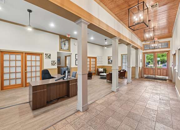 A spacious office with wood floors and a reception desk.