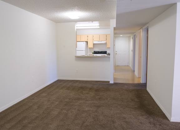 A room with brown carpet and white walls.