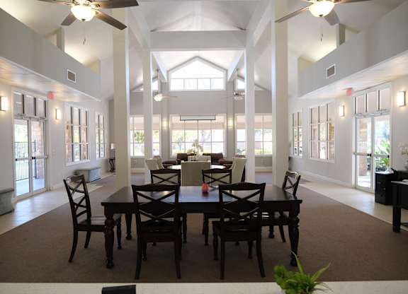 A dining room with a table set for six.