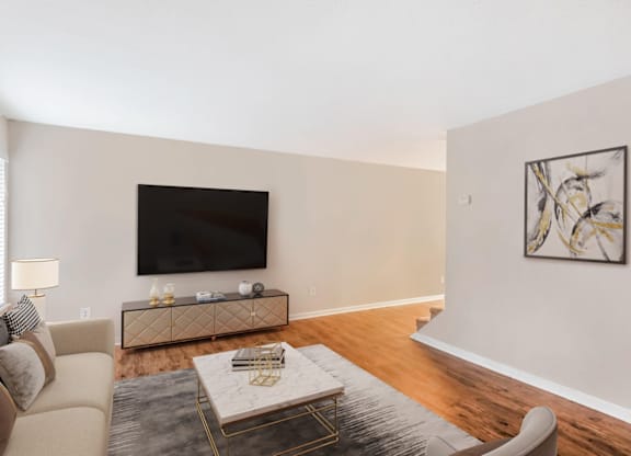 A living room with a couch, coffee table, and a painting on the wall at Regency Park Apartment Homes, Raleigh, NC, 27616