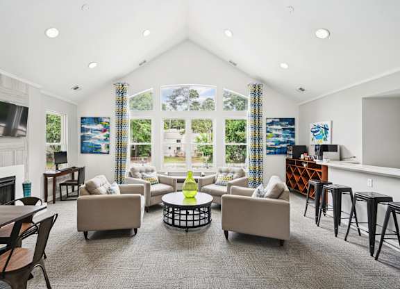 A living room with a fireplace and a large window at Regency Park Apartment Homes, Raleigh, North Carolina