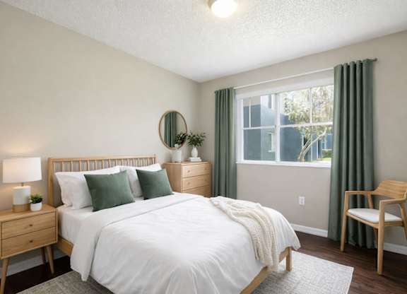 A bedroom with a bed, nightstand, and chair.