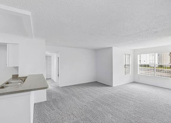 Interior of apartment facing the kitchen and dining area from the living room