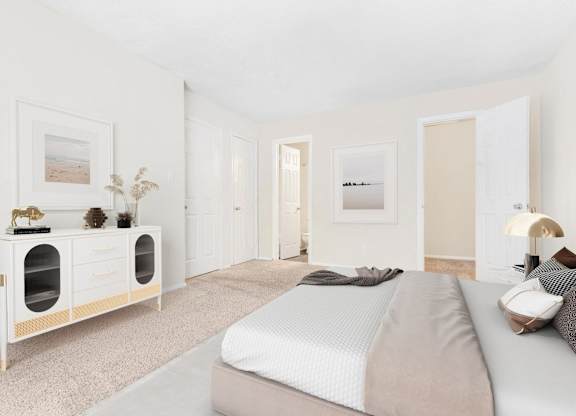 A bedroom with a bed, nightstand, and a cabinet with drawers.