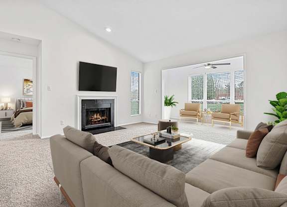 A living room with a fireplace and a television.