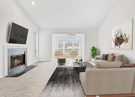 A modern living room with a fireplace and a large couch.