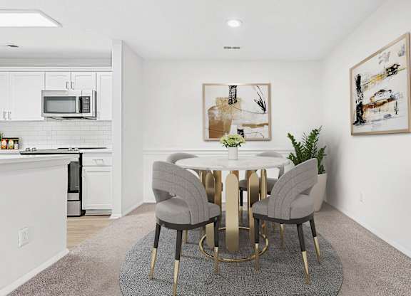 A modern dining room with a white table and grey chairs.