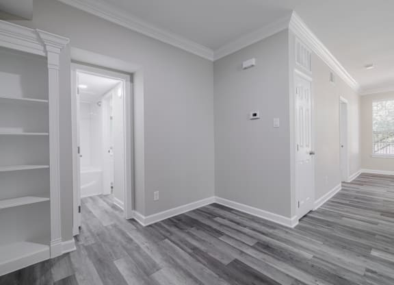 room with hardwood-style flooring and built-in shelving