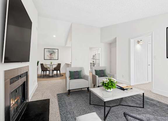 A living room with a fireplace and a couch. at Woodlyn on the Green Apartment Homes, Cary, 27513