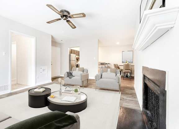A living room with a fireplace and a couch. at Woodlyn on the Green Apartment Homes, Cary, NC, 27513