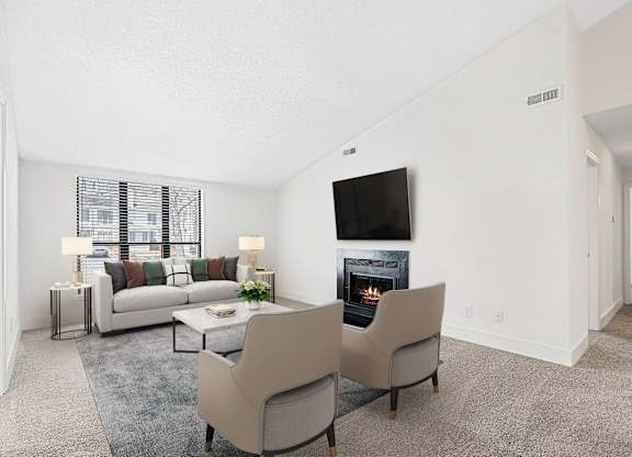 A living room with a fireplace and a television. at Woodlyn on the Green Apartment Homes, North Carolina