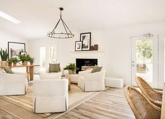 A living room with a fireplace and a chair. at Woodlyn on the Green Apartment Homes, Cary, North Carolina
