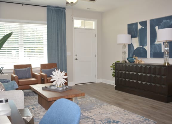 a living room with blue and brown furniture and a large window