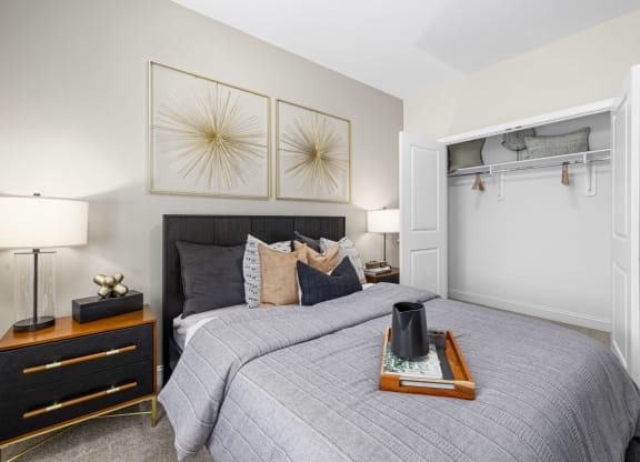 a bedroom with a bed and two paintings on the wall