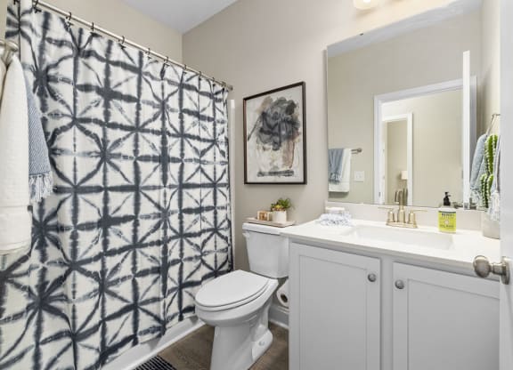 Bathroom with tub and granite countertop
