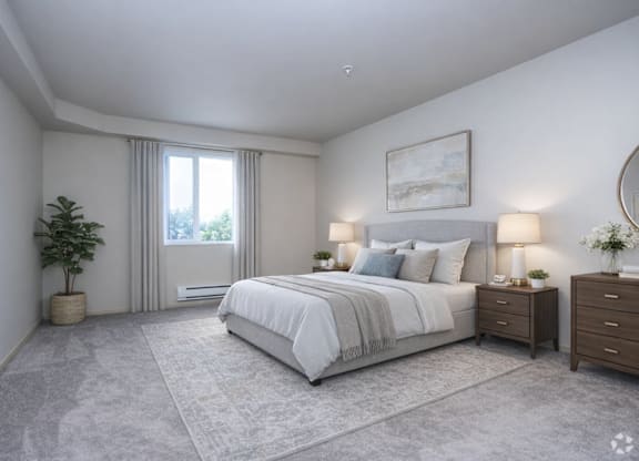A well-lit bedroom with a large bed, nightstands, and a plant.