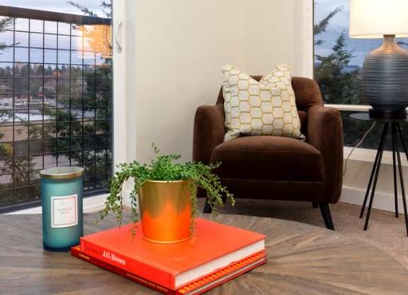 a living room with a coffee table and a chair